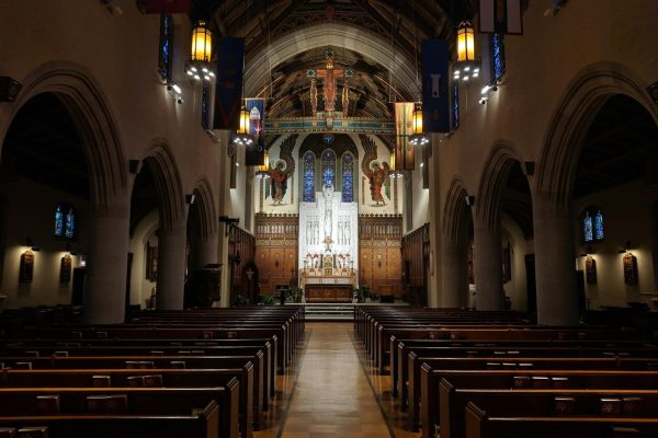 a church with pews and stained glass windows